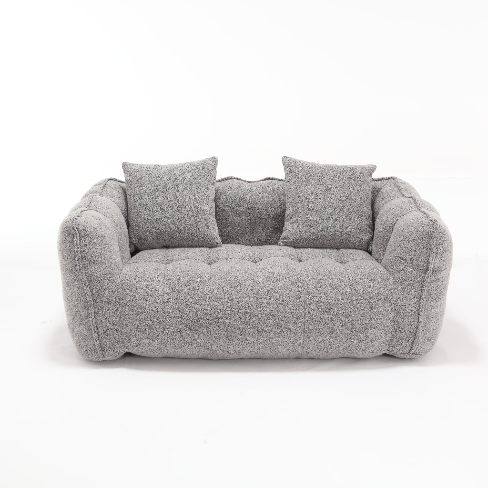 Gray sofa with two cushions on a white background